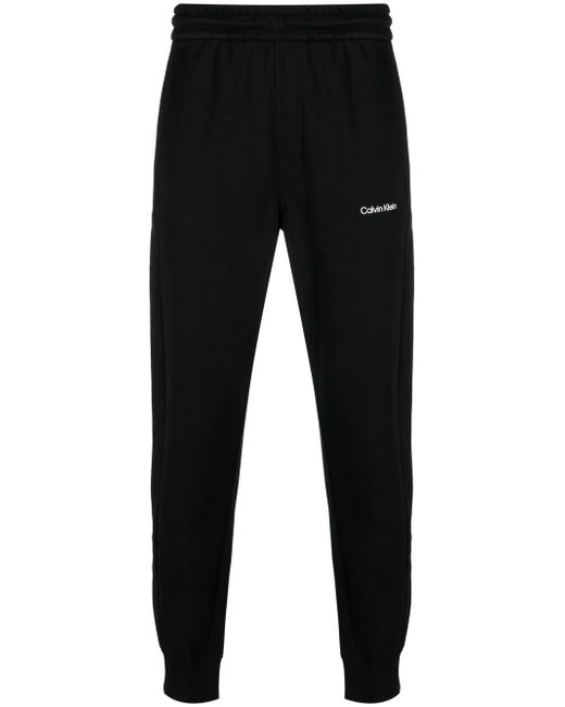 Calvin Klein logo-patch jersey track pants in Black